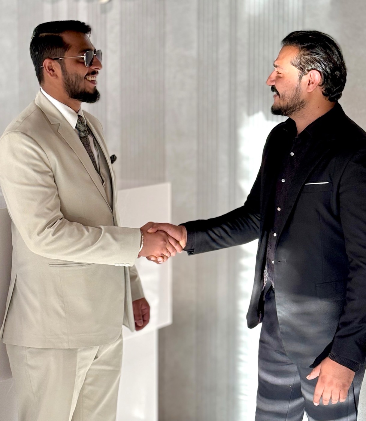 A Reta International representative welcoming a client with a handshake